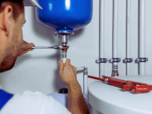 plumber installing an expansion tank on water heater