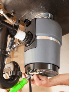 Plumber repairing garbage disposal that is not working