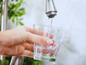 Homeowner filling up glass with tap water